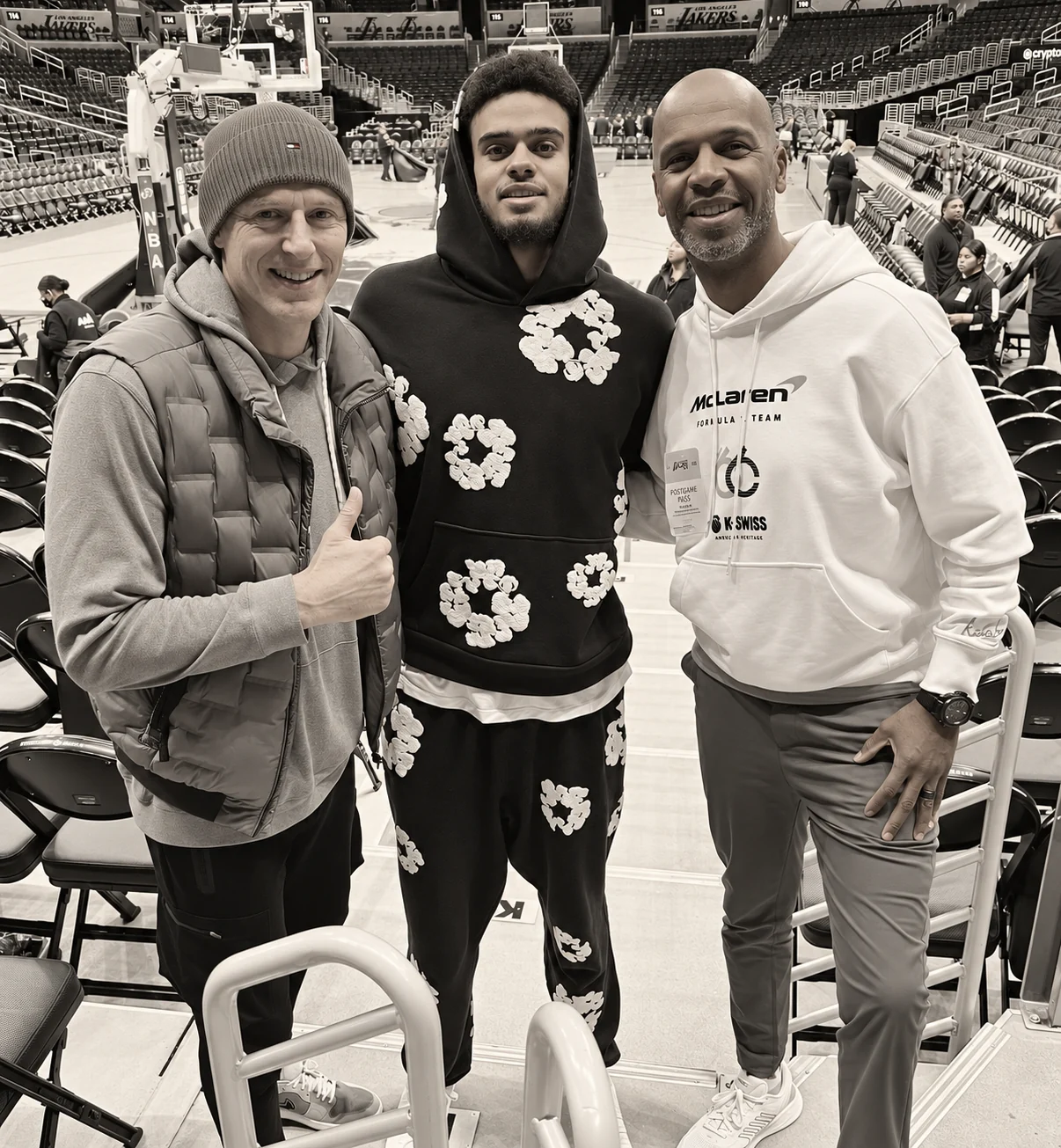 Members of the Playmakers team photographed together at a professional basketball arena